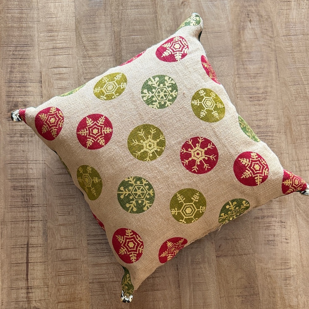 Festive Holiday Pillow with Red and Green Snowflake Design